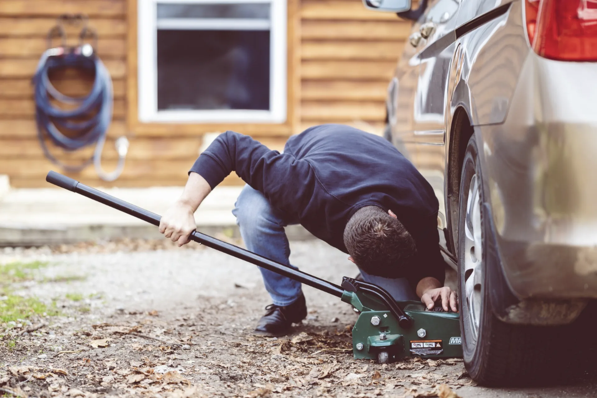 Technician using a floor jack to service a vehicle in Amarillo Texas TX