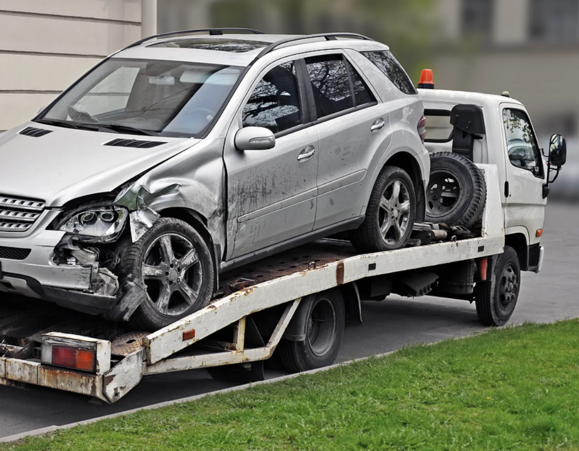 Wrecked SUV secured on a flatbed tow truck in Amarillo Texas TX